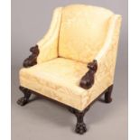 A mahogany upholstered arm chair. With carved acanthus leaf arms and lion paw feet supports. Overall