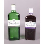 Two sealed bottles of Gordon's Gin.