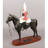 A Beswick Connoisseur model of a trooper on horse back, titled Life Guard. Reigns broken. Signs of