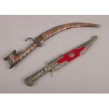 Two daggers. An Eastern curved dagger in wooden sheaf & a turkish dagger with metal decoration to