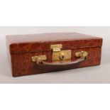 A Crocodile jewellery/vanity case with brown velvet lining. Embossed with the initials E.M.P. and