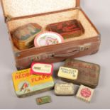 A vintage suitcase with contents of tins. Includes Redbreast Flake examples etc.