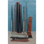 Four fishing rods, including Silstar GT and Intrepid Super Action, with sleeves and hard cases.