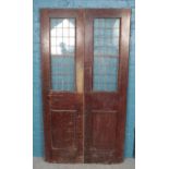 A pair of mahogany doors. With lead glazed glass windows. (203cm x 54cm)