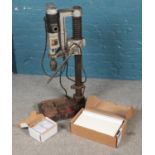 An AEG 110 volt industrial pillar drill on stand along with a fuse box, etc.