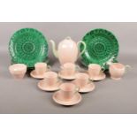 A Grindley 'Peach Leaf Petal' coffee set for six with five Wedgwood Majolica sunflower plates.