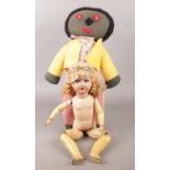 A vintage jointed doll, along with a soft toy.
