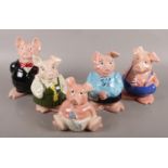 Five ceramic NatWest pigs.