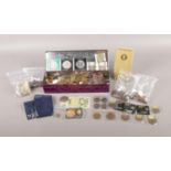 A tin of assorted GB pre decimal and World coins. To include Victorian pennies, a one pound note,