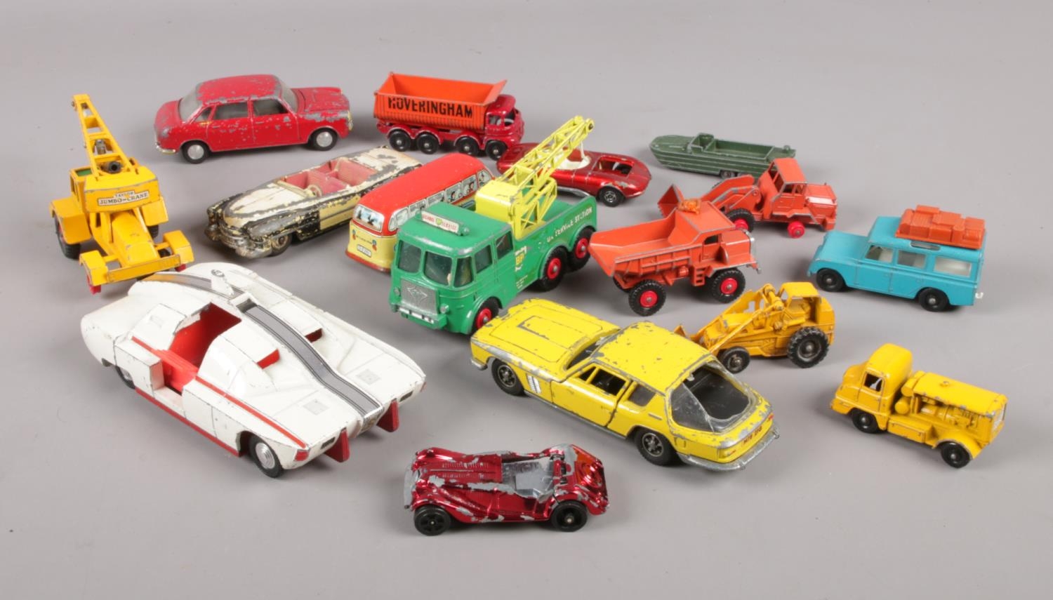 A quantity of diecast vehicles. Including Dinky Armoured Vehicle, Jensen FF, Matchbox, etc. Play