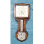 An early 20th century wall clock/barometer. the top set with a square dial with silvered chapter