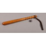 A hardwood Police truncheon with leather strap and enamel police badge. Comprising of an enamel