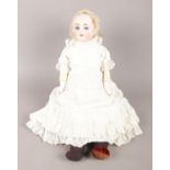 An Ernst Heubach (1887-1932) bisque doll, with leather body and original clothing. Stamped on the