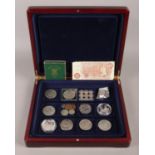 A collection of coins, including ten shilling note, nine silver three pence pieces and 1951 Festival