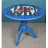 A painted kitchen table with The Who decoration to top. 82cm height 90cm diameter.
