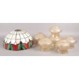 A set of six glass light shades with frilled edging and etched decoration, together with Tiffany