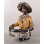 A plaster figure of a man carrying a basket. 40cm height.