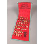 A collection of forty 'Golly badges' with a cloth display hanger named 'Golly Brooch Collection'.