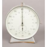 A Junghans stop clock, on painted plinth, in working order. Height: 25cm, Diameter: 21cm.