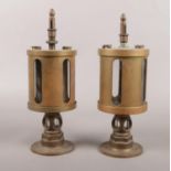 Two late 19th/early 20th century brass drip feed oil lubricators. 24cm height.