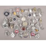 A collection of metal badges. Includes police, fire, ambulance etc.