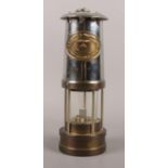A Brass & metal Welsh miners lamp. Marked Thomas & Williams Ltd, Aberdare, No 106614. 26cm height.