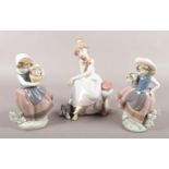 Three Lladro figures. Includes pair of girls with flower baskets and Chit Chat. Chips and damage