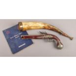 A reproduction Hawkins flintlock pistol, together with a copper and brass mounted hunting horn and