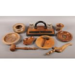 An assortment of wooden turned and carved items. To include a wooden writing set with two glass