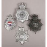 Four metal police helmet badges. Includes West Mercia, Metropolitan, Gloucestershire and Cheshire.