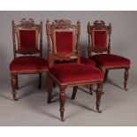 Four carved oak dining chairs with red velvet upholstery. Comprising of carved decoration, finials