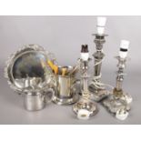 A collection of silver plated items. Includes three candlesticks converted to table lamps, wine