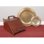 An oak coal scuttle and two brass chargers.