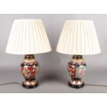 A pair of Chinese ceramic table lamps, produced by C.A. Lighting. Small scuffs to bases.