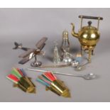 A selection of metalwares. To include a white metal desk top aeroplane, two pewter perfume