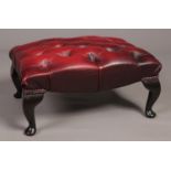 An ox blood deep buttoned studded leather Chesterfield foot stool.