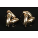 A pair of yellow metal earrings, formed as a triangular knot. Total weight: 0.89g Missing backs.