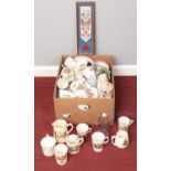A box of commemorative wares. Including display plates, mugs, glassware, etc.