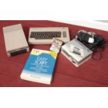 A Commodore 64 along with a boxed 1530 Datassette Unit, Commodore 154i and other accessories.