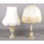 Two onyx table lamps, including one with gilt metal mounts. Discolouration to shades. Bases are