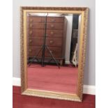 A gilt framed bevel edge wall mirror. 86.5cm x 61cm.