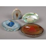 Three pieces of agate along with an abalone shell.