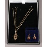 A 9ct Gold and Garnet jewellery suite. To include dainty necklace and a pair of earrings. Total