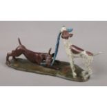 Judy Mitchell, a cold painted bronze sculpture of two dogs playing, titled Tug.