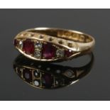 An 18ct gold diamond and red coloured stone ring. Size L. 2.81g.