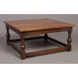 An Ercol coffee table with turned supports. (34cm x 69cm x 69cm)