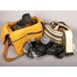 A Canon Ae-1 and a Canon EOS 100, two camera bags and lenses including Vivitar series 1 70-210mm