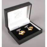 A boxed pair of silver cufflinks, topped with polished stone. Stamped 925.