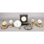 A small quantity of torsion clocks, all missing domes, together with a slate mantle clock and