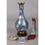 Four pieces of cloisonne. Includes vase on wooden stand, bell and two trinket boxes.